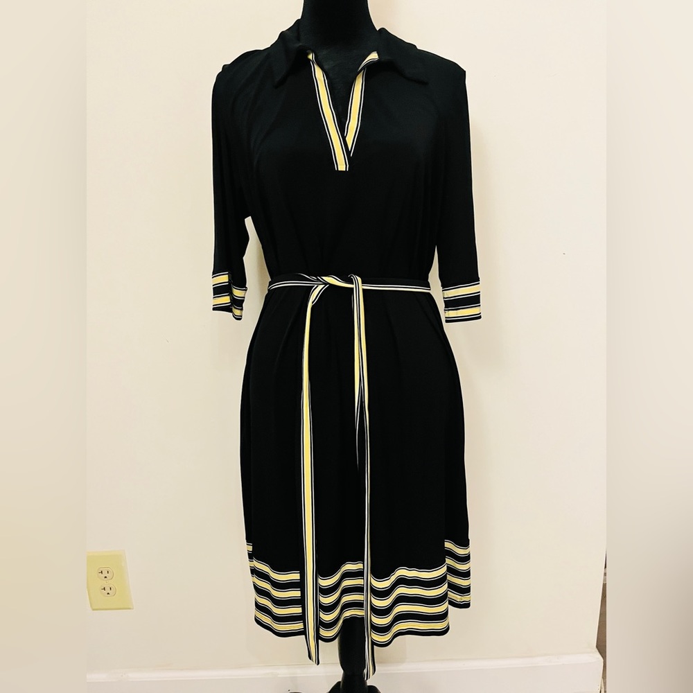 Black dress with yellow and black stripes at arms and bottom hem, waist tie